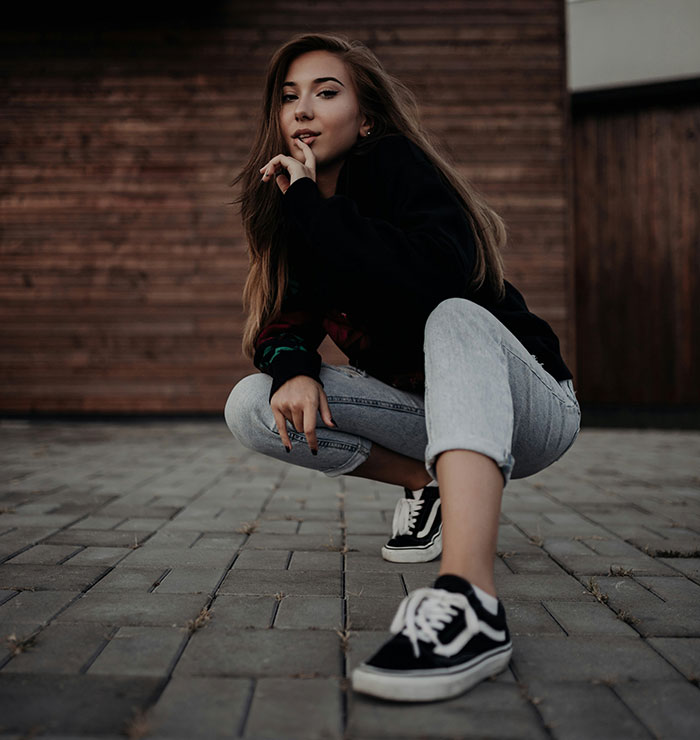 Teen girl posing outdoors, reflecting the complex emotions of parents who disowned their children in difficult situations.