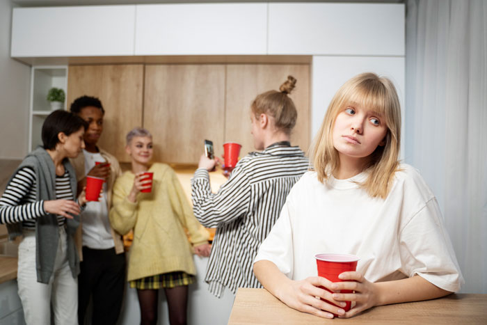 Young woman at party looking suspicious after fiancé and cousin caught together in bathroom, innocence claims rejected. Young woman at party looking suspicious after fiancé and cousin caught together in bathroom, innocence claims rejected.