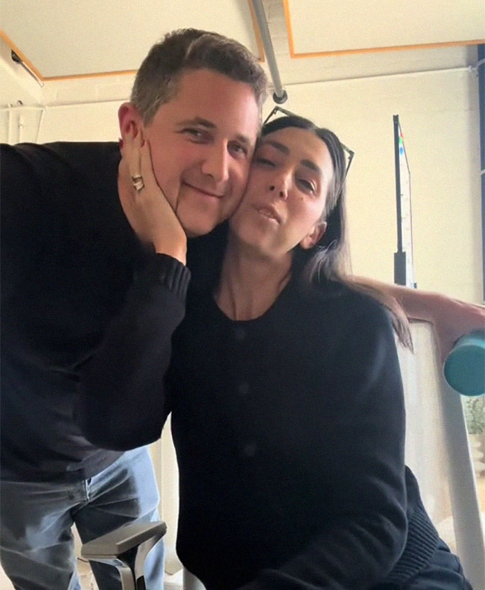 Plane passenger and companion posing indoors, with the passenger making a salad mid-flight causing controversy. Plane passenger and companion posing indoors, with the passenger making a salad mid-flight causing controversy.
