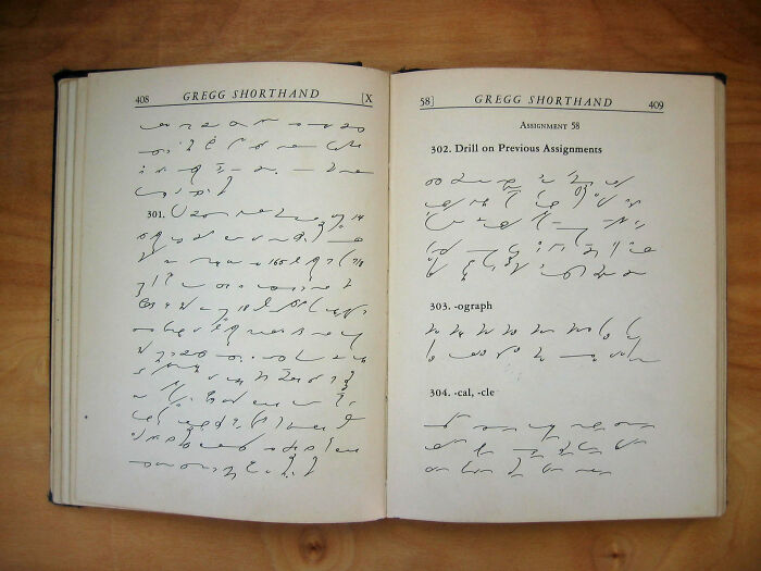 Open book showing Gregg shorthand practice, illustrating outdated skills people online needed before the 2000s but don't need now.