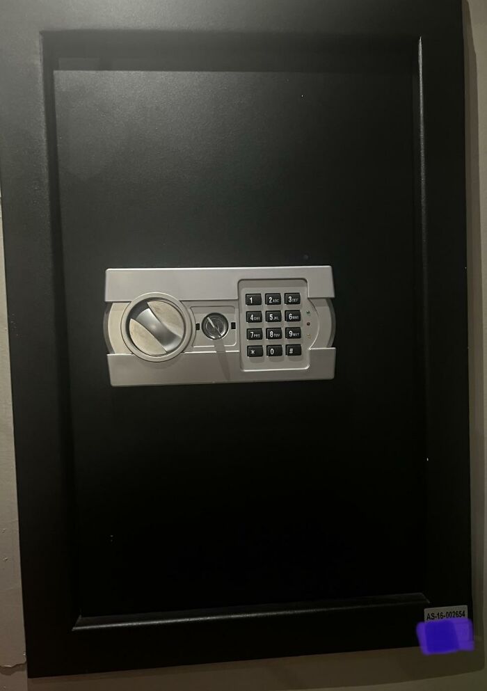 Black wall-mounted safe with digital keypad and dial lock symbolizing disturbing things found after a loved one’s death.