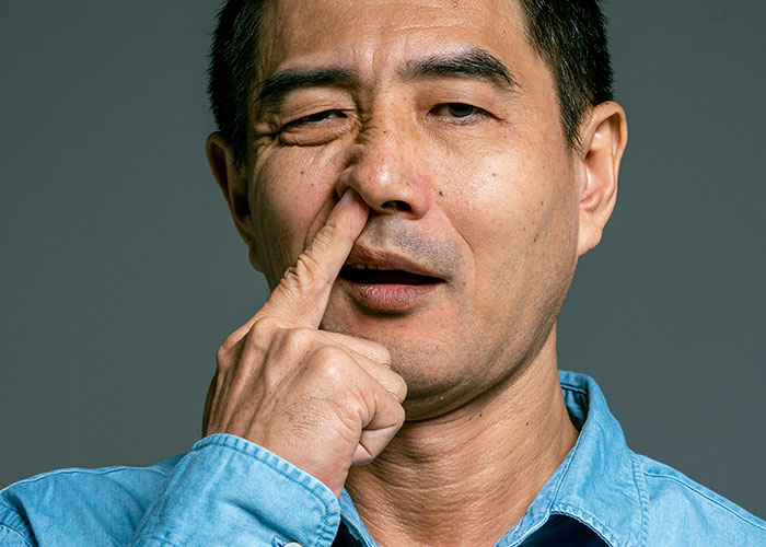 Middle-aged man picking his nose, expressing a dark secret people willingly admitted to anonymously.