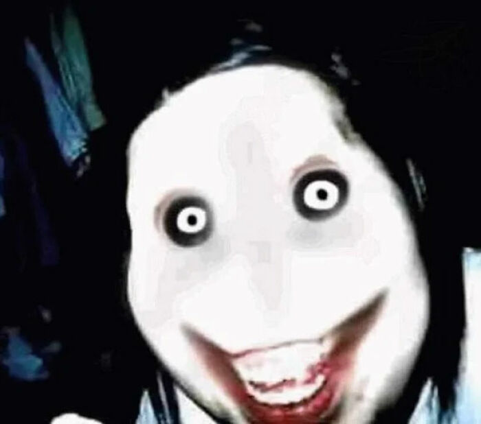 Disturbing face with exaggerated eyes and smile, representing the scariest things that happened to people while online.