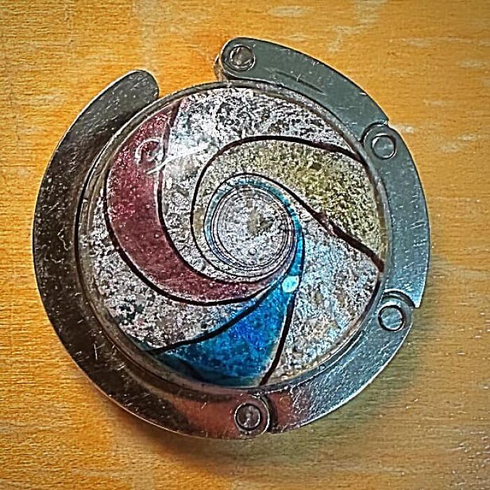 Colorful vintage spiral souvenir found in walls or hidden places that really confused people, showing wear and details.