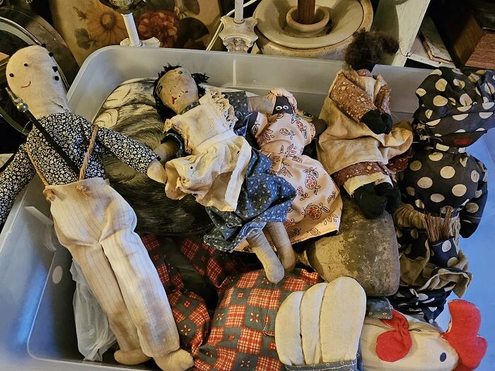 A collection of vintage cloth dolls found hidden in unusual places, confusing those who discovered them.