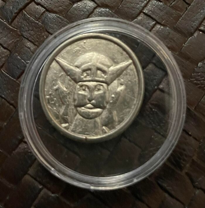 Silver coin with a mysterious Viking or warrior face design found in walls or other places that really confused people