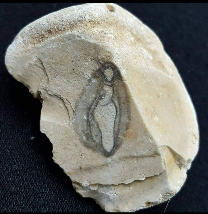 Close-up of a mysterious stone fragment with unusual markings found in walls or other places that really confused people.