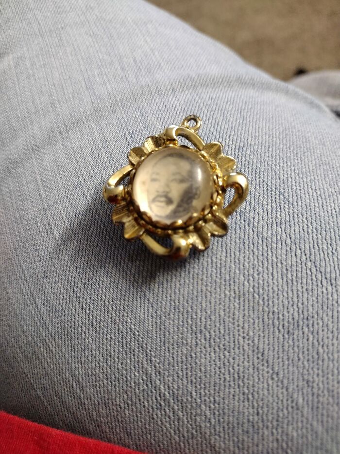 Small vintage gold pendant with a blurry portrait found in walls or other places that really confused people