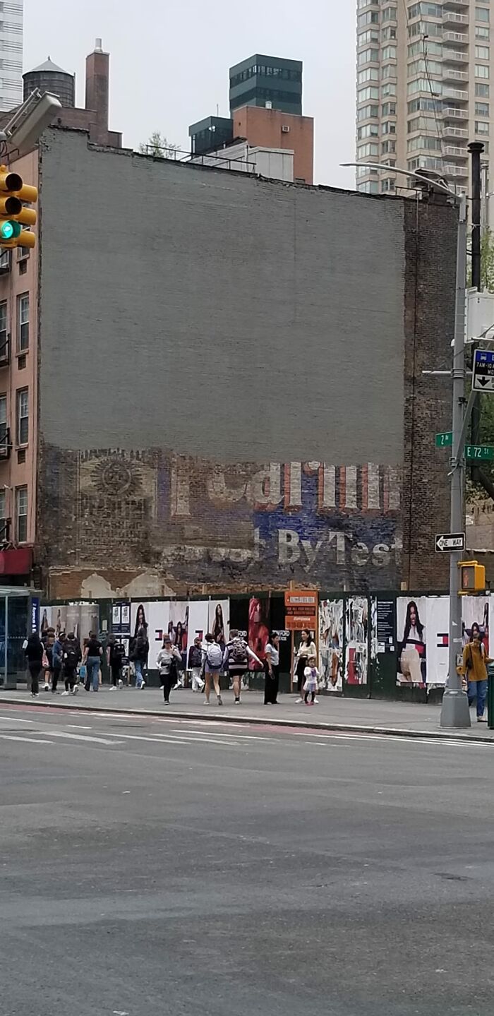 Faded vintage advertisement painted on urban brick wall, an unexpected thing people found in their walls that really confused them.