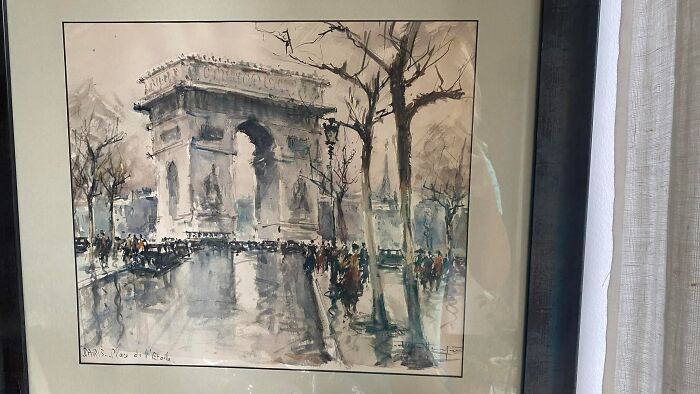 Framed watercolor painting of a Parisian arch found hidden in walls, showcasing unique things people discovered in their walls.