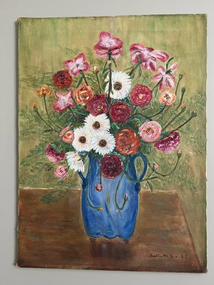 Oil painting of colorful flowers in a blue vase, an unusual thing people found in their walls or other places.