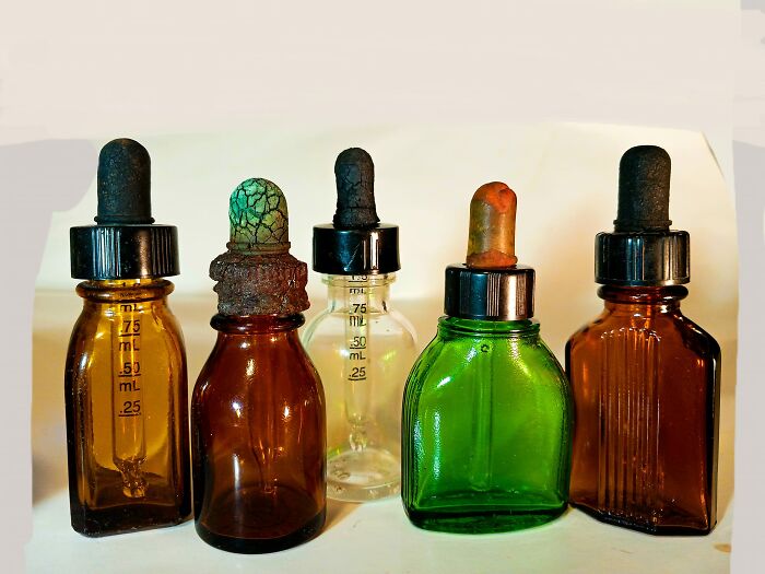 Old glass dropper bottles with worn rubber tops found in walls or other hidden places that really confused people
