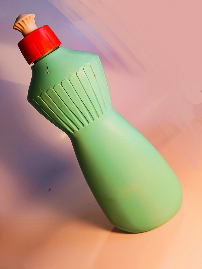 Old green plastic bottle with a red cap, one of the unusual things people found in their walls or other hidden places.