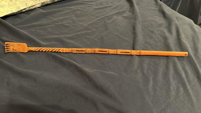 Carved wooden object found in walls or hidden places, sparking curiosity and confusion about its purpose and origin.