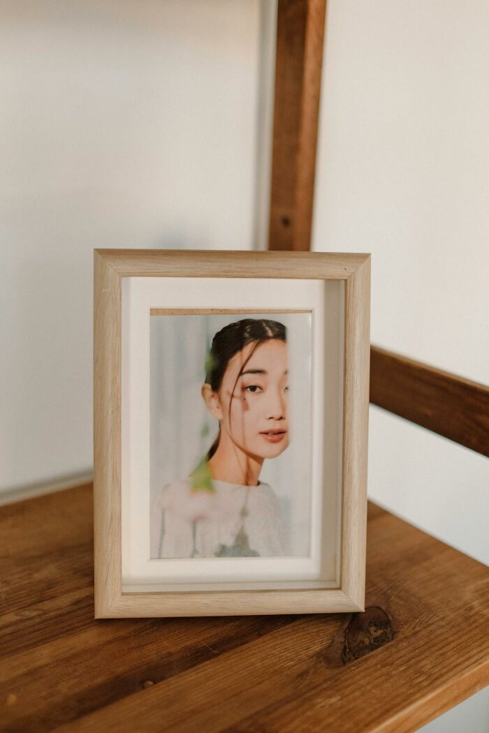 Portrait photo in a wooden frame on a table, illustrating women sharing wildest things their exes got away with.