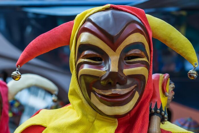 Close-up of a person in a creepy jester mask and costume, evoking scary moments from truck drivers' lives.