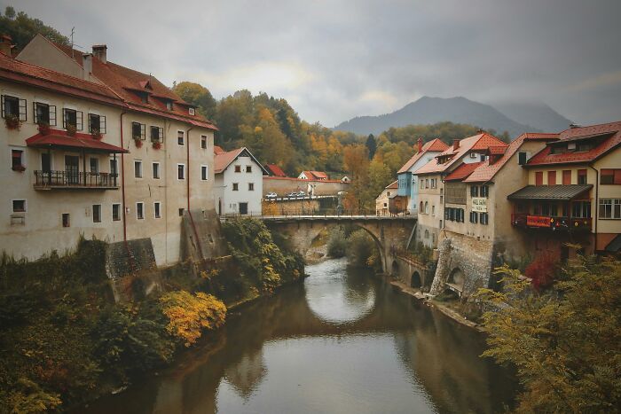 Scenic European town with historic buildings and a bridge over a river, illustrating European netizens correcting common facts.