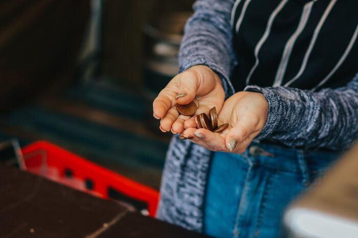 Person holding vintage chocolate coins in hands, capturing unique childhood joys before smartphones era.