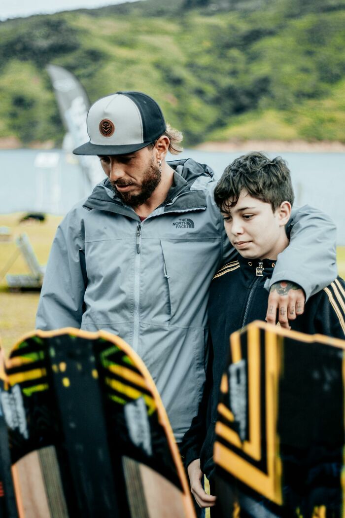 Man and boy outdoors near water, showing a moment of connection despite challenges with worst parents issues.