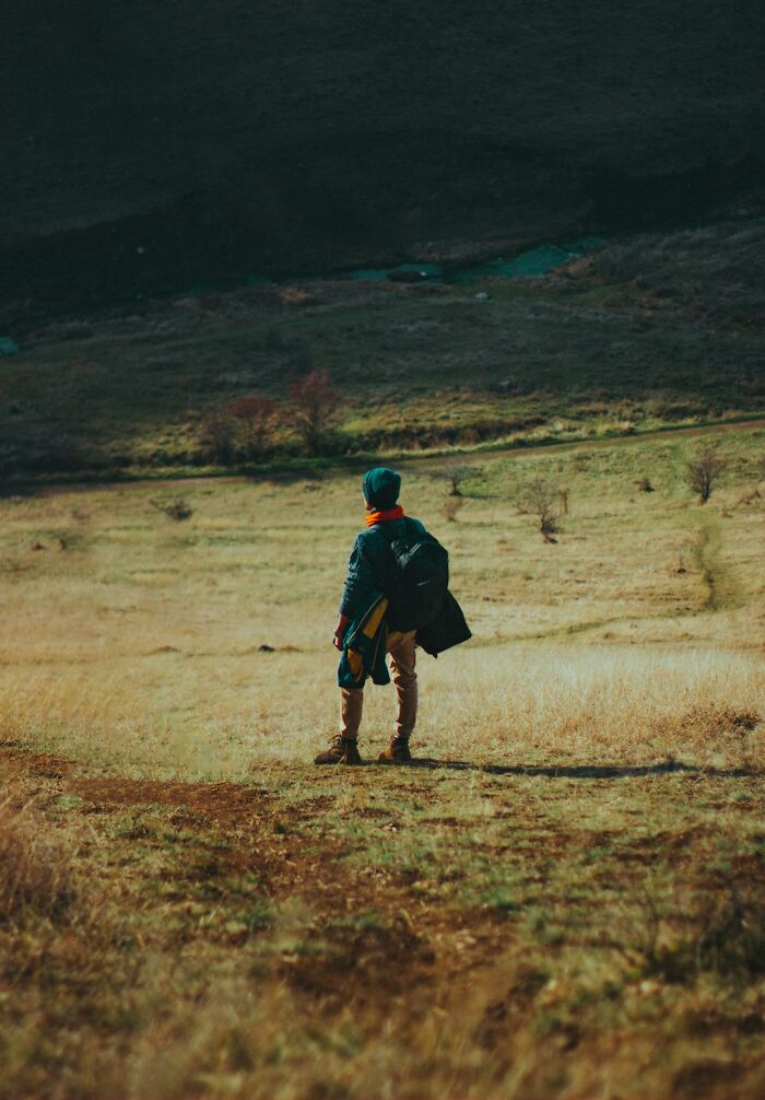 Child exploring open field alone, capturing unique childhood joys before smartphones changed how memories are recorded.