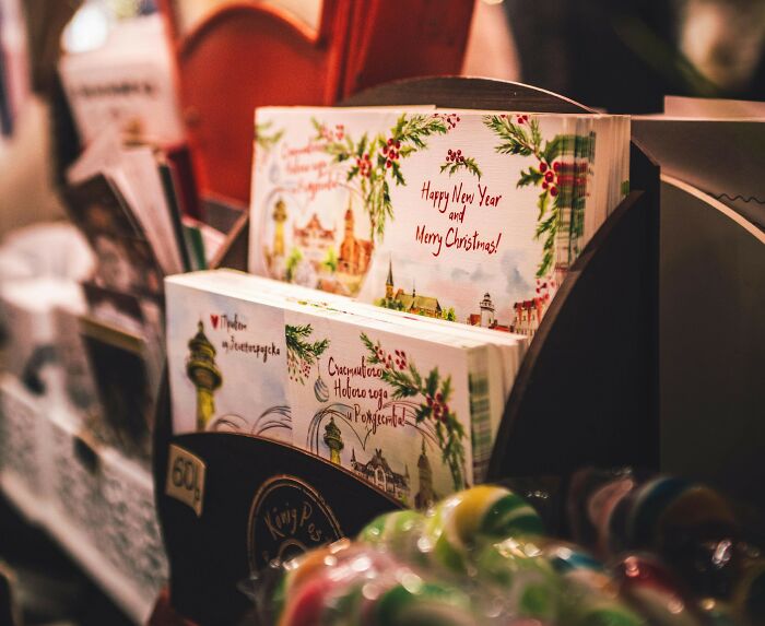 Holiday greeting cards displayed on a rack with festive decorations highlighting a good trend slowly disappeared over time.