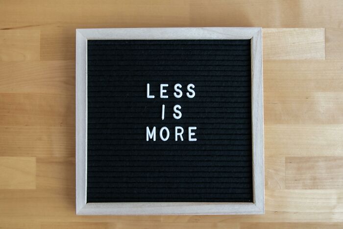 Black felt letter board with white letters spelling less is more, illustrating commonly misheard phrases in everyday English learning.