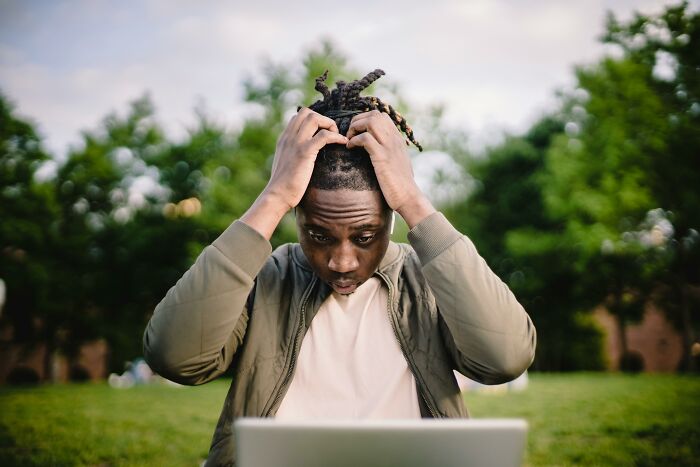 Young man looking confused while working on a language quiz outdoors, illustrating mind-bending questions concept. Young man looking confused while working on a language quiz outdoors, illustrating mind-bending questions concept.