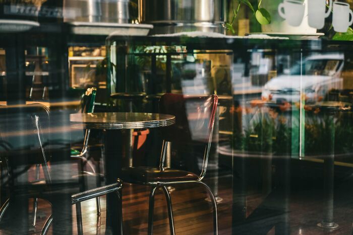 Empty cafe with vintage chairs and tables, symbolizing stories of people ruining their life with one wrong deed shared online.