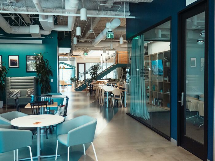 Modern office space with open seating and conference rooms illustrating companies that crashed after key employee departure.