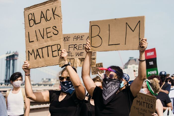 Protesters holding Black Lives Matter signs, illustrating moments people forgot their privilege in real world context.