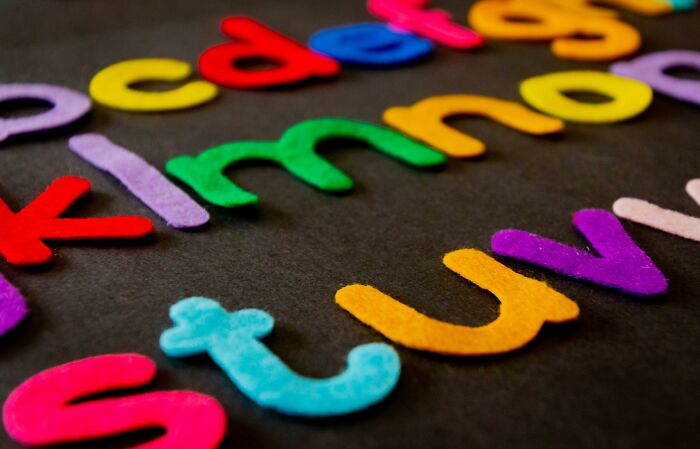 Colorful felt letters scattered on a dark surface, illustrating the challenge to score above 21/27 in a genius test. Colorful felt letters scattered on a dark surface, illustrating the challenge to score above 21/27 in a genius test.