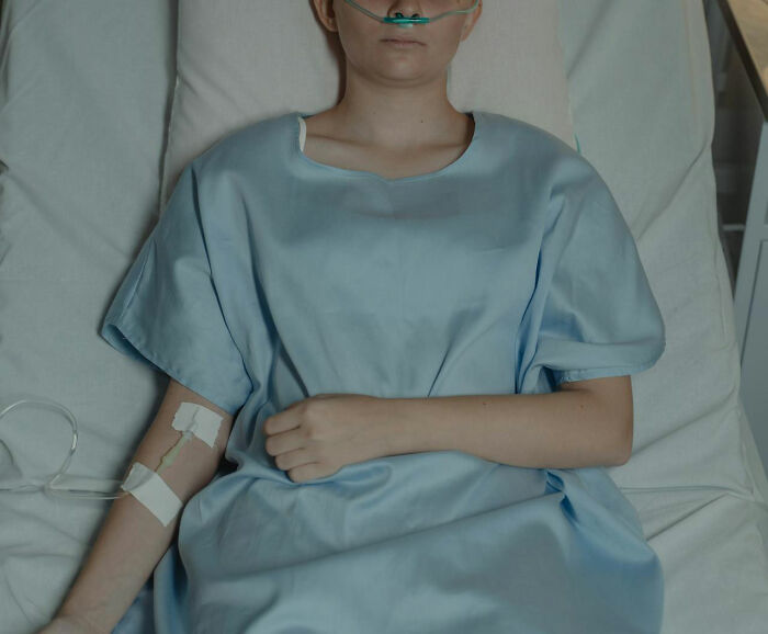 Young patient in hospital bed with IV and oxygen tube, symbolizing the consequences of terrible parents revealed publicly.