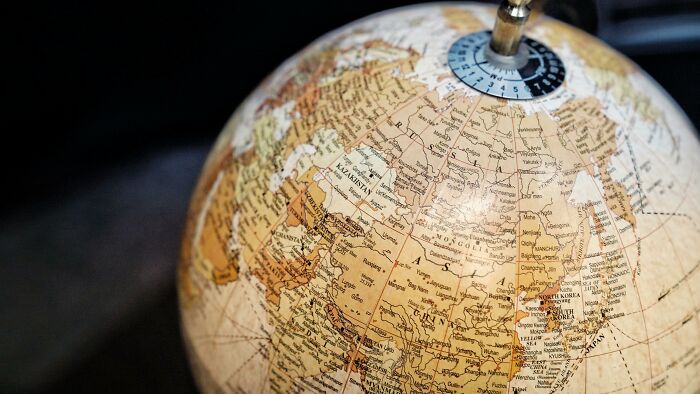 Close-up of a detailed vintage globe showing countries and borders, illustrating fictional things that were never real.