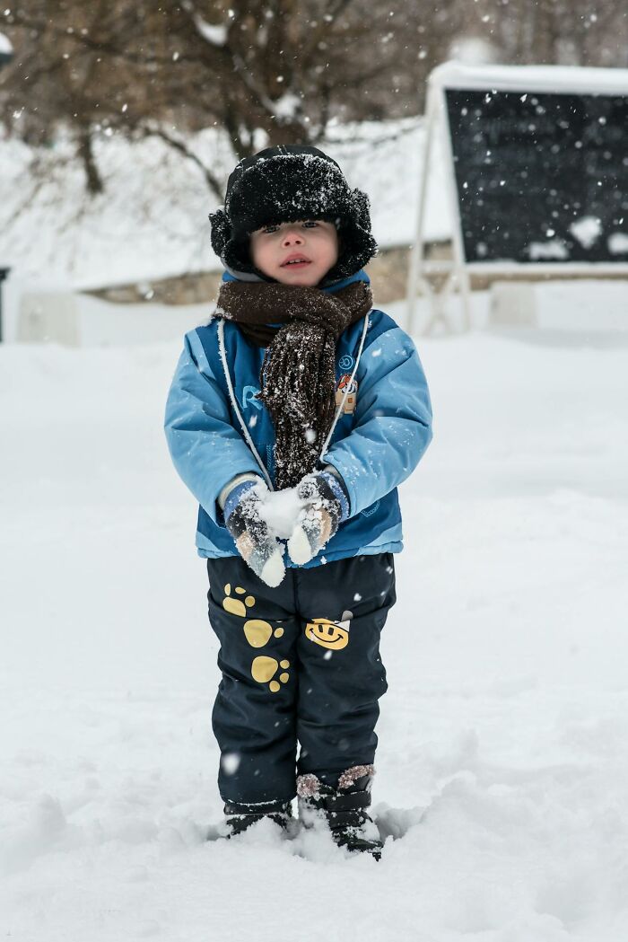 Child in winter clothes standing in snow, illustrating themes related to worst parents in cold weather situations.