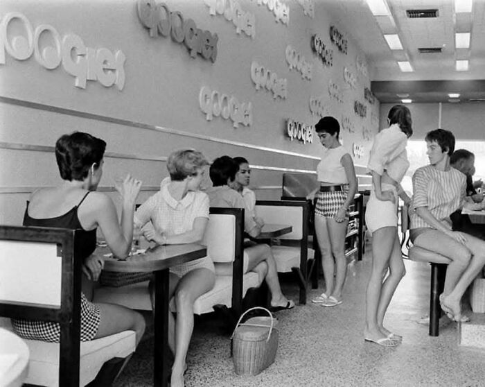 Vintage black and white photo of young women in a diner, capturing timeless moments to show what the past looked like.