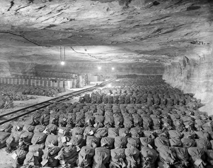 Large underground storage of sandbags in a historic wartime bunker showing timeless photos of the past.