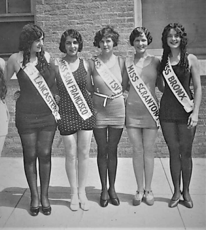 Vintage photo of beauty contestants wearing sashes representing past American cities in timeless photos from the past.
