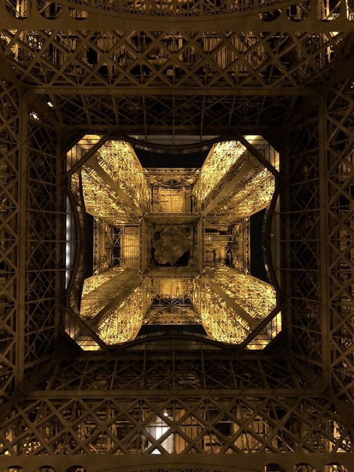 Illuminated metal framework viewed from below showcasing photos alternative angles unseen at night.