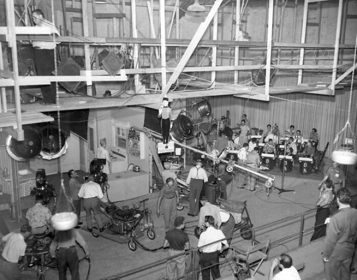 Black and white photo of a busy film set with crew and equipment showing alternative angles unseen in production.