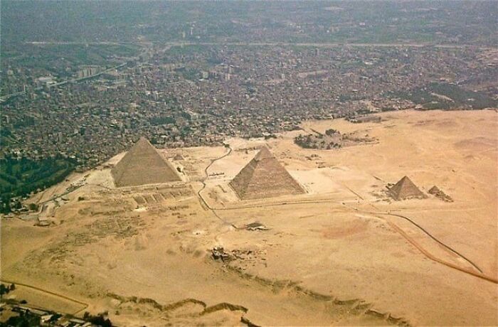 Aerial view of the pyramids with alternative angles showing unseen details of the ancient desert landscape.