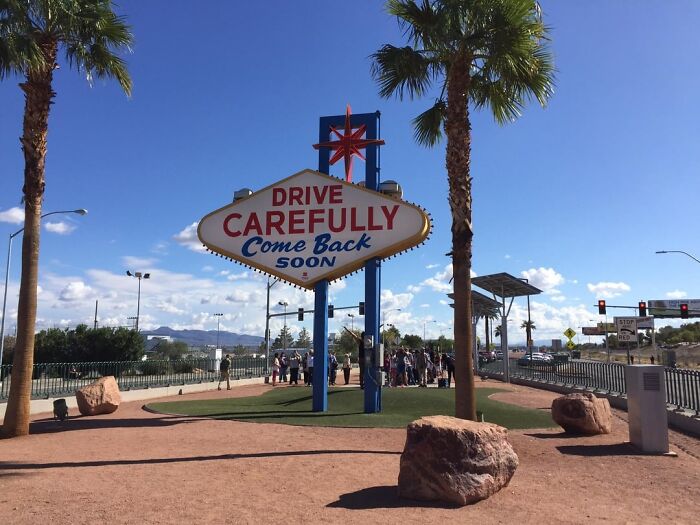 Iconic retro roadside sign under clear blue sky, captured from alternative angles showcasing unseen perspectives and vibrant surroundings.