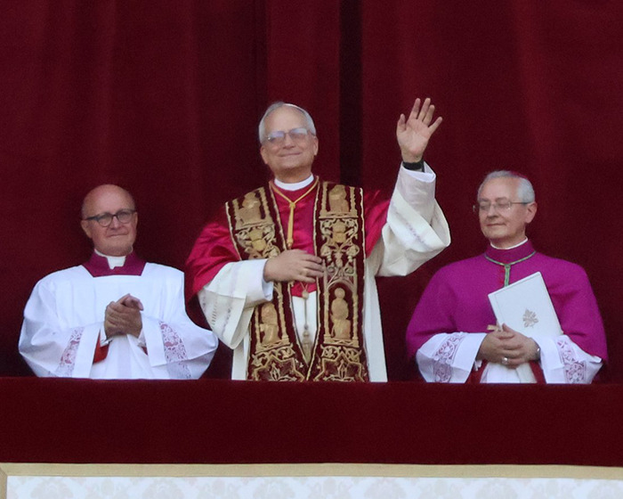 Pope Leo XIV dressed in ceremonial robes with two clergymen, highlighting nepopetism controversies and reactions.