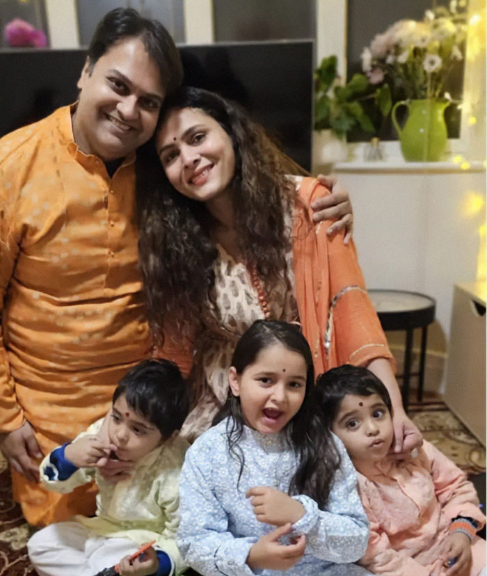 Family smiling together indoors wearing traditional clothes in final moment captured inside Air India plane before disaster struck