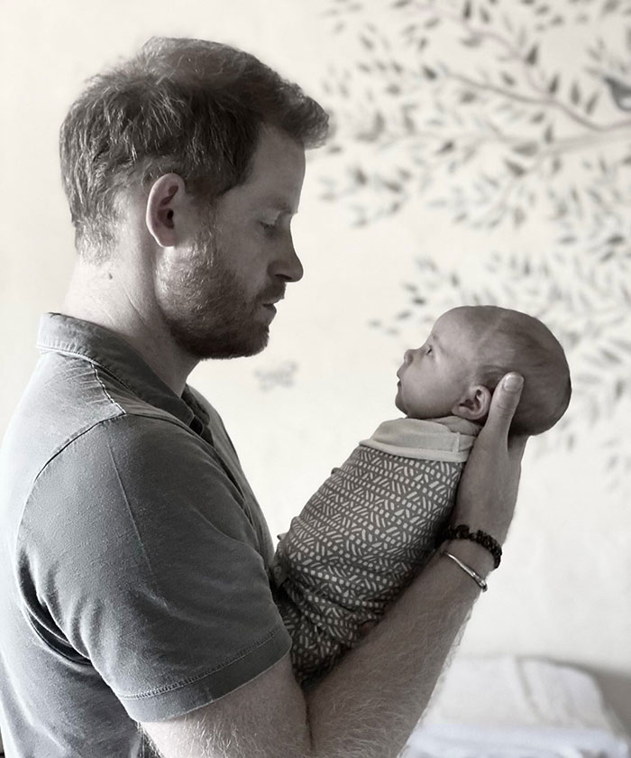 Man holding a baby wrapped in a blanket, representing Meghan Markle Father's Day post criticized over paid child actors and rented kids. Man holding a baby wrapped in a blanket, representing Meghan Markle Father's Day post criticized over paid child actors and rented kids.