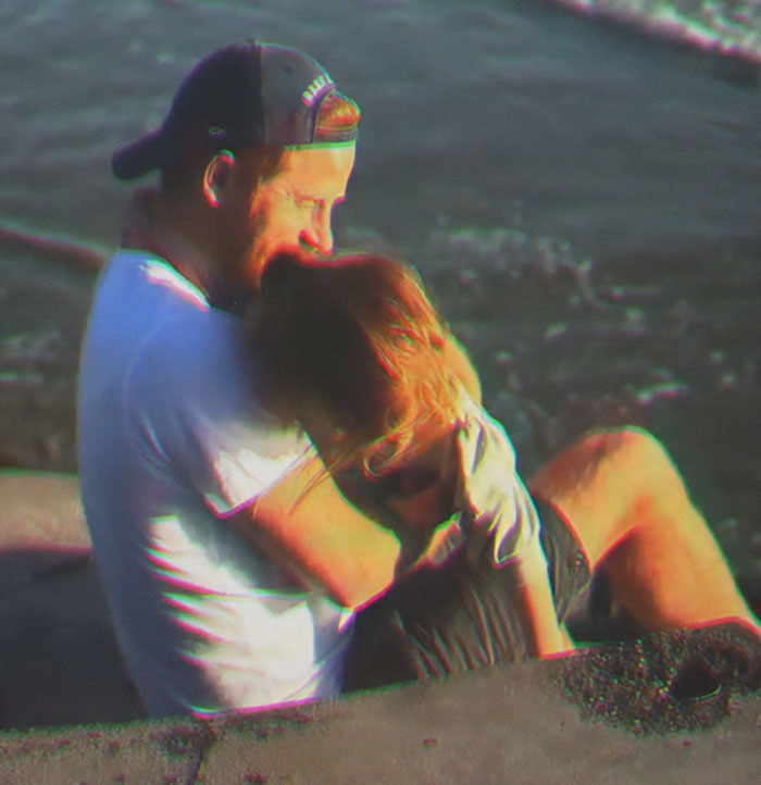 Man in a cap hugging child by the water, related to Meghan Markle’s Father's Day post and paid child actors controversy. Man in a cap hugging child by the water, related to Meghan Markle’s Father's Day post and paid child actors controversy.