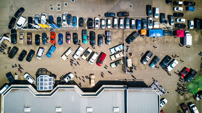 Aerial view of a private school parking lot filled with cars, illustrating rich kid meltdowns at private schools.