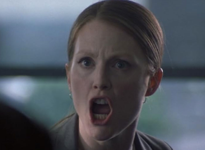 Woman with a tense expression speaking loudly, illustrating psychologists sharing stories of patients who scared them.