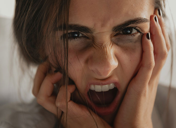 Close-up of a frightened woman showing intense fear and anxiety, illustrating patients who genuinely scared psychologists