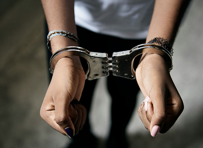 Hands in handcuffs with bracelets worn by a person, representing patients who genuinely scared psychologists.