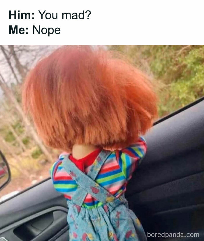 Child doll with messy red hair leaning against a car window with meme text about not being mad, funny memes to decompress.